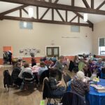Several of the tables with attendees at them